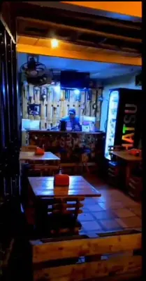 a restaurant with tables and a man in the background at Confort Compartida Ctg x3 in Cartagena de Indias