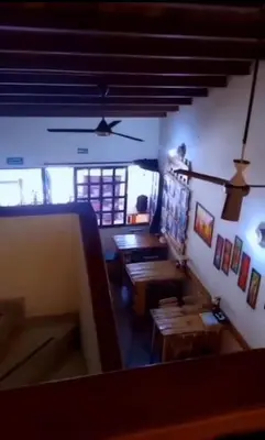 a dining room with wooden tables in a building at Confort Compartida Ctg x3 in Cartagena de Indias