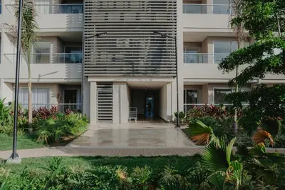 an apartment building with a courtyard in front of it at Coastal Comfort Retreat Beach stay Near Airport in Santa Marta