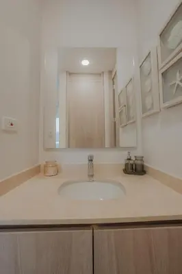 a bathroom counter with a sink and a mirror at Coastal Comfort Retreat Beach stay Near Airport in Santa Marta
