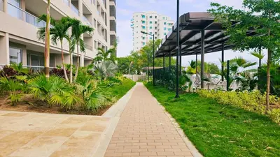 a walkway in front of a building with palm trees at 1BD Luxe Shore & Balcony Sunrise Next to the Beach in Santa Marta