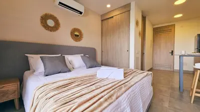 a bedroom with a large bed in a room at 1BD Luxe Shore & Balcony Sunrise Next to the Beach in Santa Marta