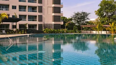 a swimming pool in front of a building at Luxe Shore & Balcony Sunrise 1108 in Santa Marta