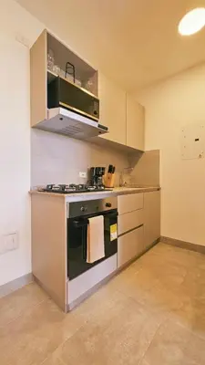 a kitchen with an oven and a stove top at Luxe Shore & Balcony Sunrise 1108 in Santa Marta