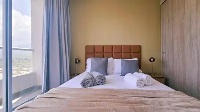 a bedroom with a large bed with towels on it at Luxe Shore & Balcony Sunrise 1108 in Santa Marta