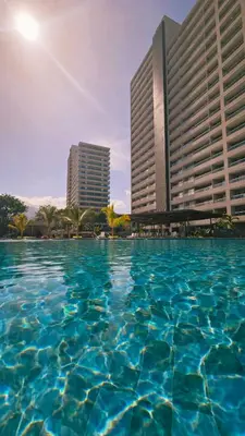 a pool of water in front of two buildings at Luxe Shore & Balcony Sunrise 1108 in Santa Marta