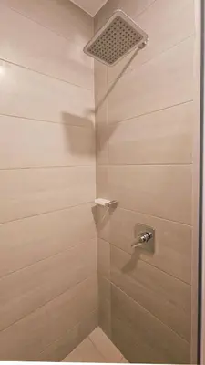 a shower with a glass door with a shower head at Caribbean Retreat Direct Beach Access in Santa Marta