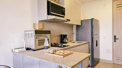 a kitchen with a counter with a sink and a refrigerator at Caribbean Retreat Direct Beach Access in Santa Marta