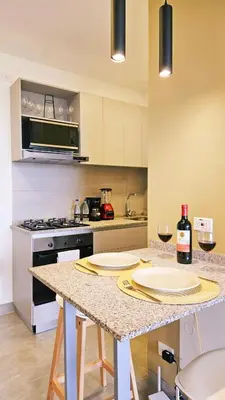 a kitchen with a counter with two plates on it at Seaside Retreat Beach Entrance 20th Floor in Santa Marta