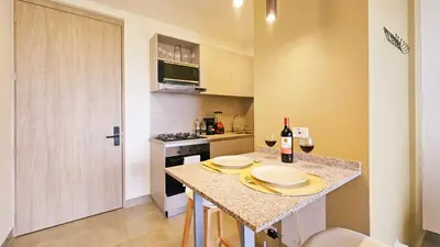 a kitchen with a counter with two plates on it at Seaside Retreat Beach Entrance 20th Floor in Santa Marta