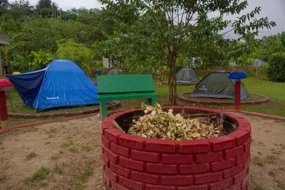 a pile of bricks with tents and a green table at Hostal Cultural El Telar in San Jacinto