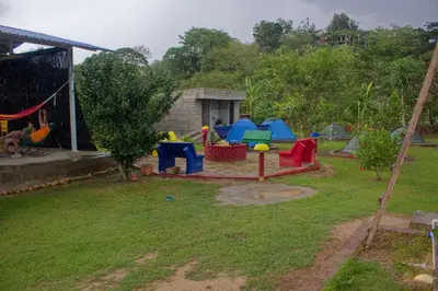 a backyard with a play area with a playground at Hostal Cultural El Telar in San Jacinto