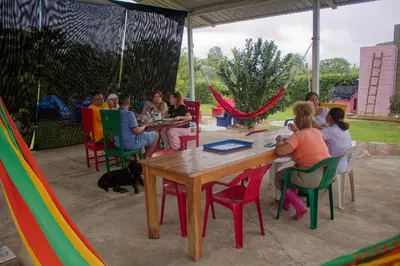 a group of people sitting at a table under a tent at Hostal Cultural El Telar in San Jacinto