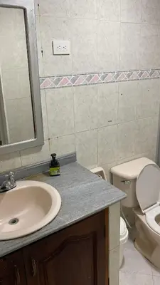 a bathroom with a sink and a toilet and a mirror at Habitación cerca al aeropuerto # 5 in Cartagena de Indias