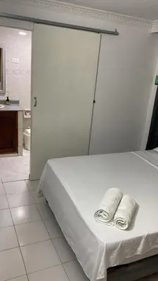 a bedroom with a bed with two towels on it at Habitación cerca al aeropuerto # 5 in Cartagena de Indias