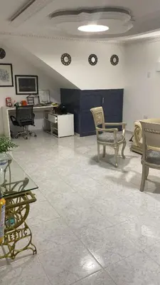 a room with chairs and desks and clocks on the wall at Habitación cerca al aeropuerto # 5 in Cartagena de Indias