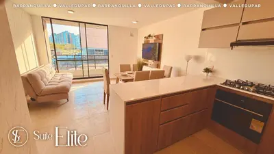 a kitchen and living room with a view of a city at Barranquilla Super Suite Elite in Barranquilla