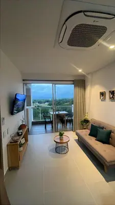 a living room with a couch and a table at Baia Kristal Andrés Cartagena in Cartagena de Indias