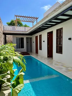 a villa with a swimming pool and a house at Casa Pozo del Carretero in Cartagena de Indias