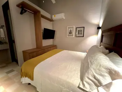 a bedroom with a bed and a television in it at Casa Pozo del Carretero in Cartagena de Indias