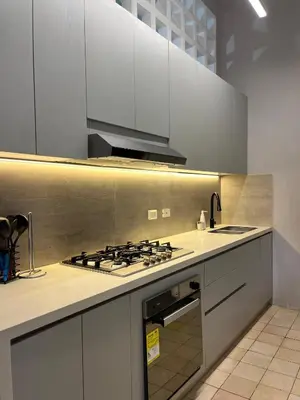 a kitchen with white cabinets and a stove top oven at Casa Pozo del Carretero in Cartagena de Indias