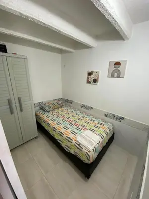 a bedroom with a bed in the corner of a room at Apartamento en Cartagena de Indias in Cartagena de Indias
