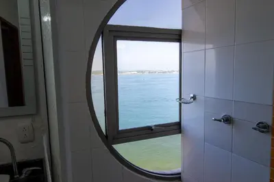 a mirror in a bathroom with a view of the water at Vita 902 Paraíso Costero in Cartagena de Indias
