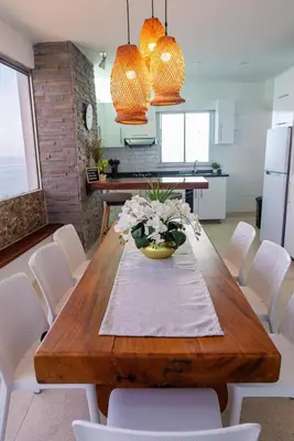 a dining room table with a vase of flowers on it at Vita 902 Paraíso Costero in Cartagena de Indias