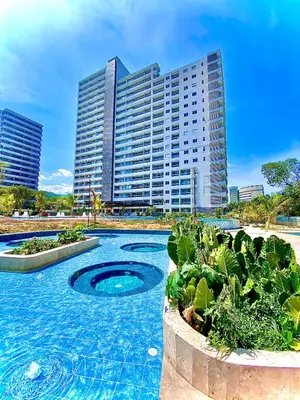 a swimming pool in front of a tall building at Anny Luxury Apartment - Santa Marina in Santa Marta