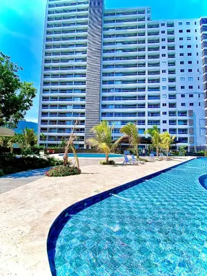 a swimming pool in front of a large building at Anny Luxury Apartment - Santa Marina in Santa Marta