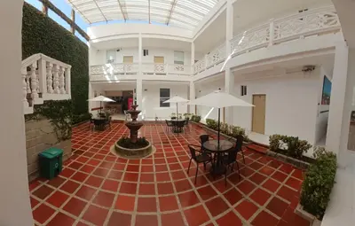 an empty room with tables and chairs and a glass ceiling at Hotel Boutique High Park in Cartagena de Indias