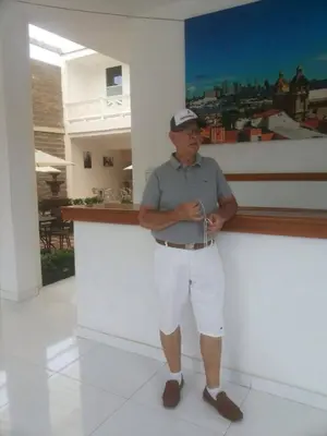 a man standing next to a counter holding a wii remote at Hotel Boutique High Park in Cartagena de Indias
