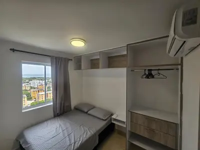 a small bedroom with a bed and a window at Apartamento Moderno 2H cerca Aeropuerto, Playas y Centro Historico in Cartagena de Indias