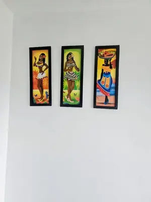 a group of four framed pictures on a wall at Apartamento Moderno 2H cerca Aeropuerto, Playas y Centro Historico in Cartagena de Indias