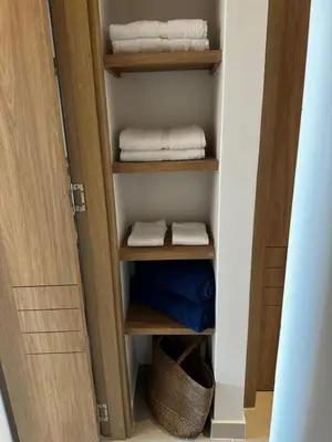 a closet with wooden shelves and towels in it at Baia Kristal Andrés Cartagena in Cartagena de Indias