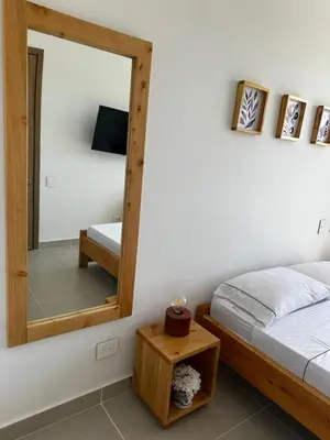 a bedroom with a bed and a mirror at Baia Kristal Andrés Cartagena in Cartagena de Indias