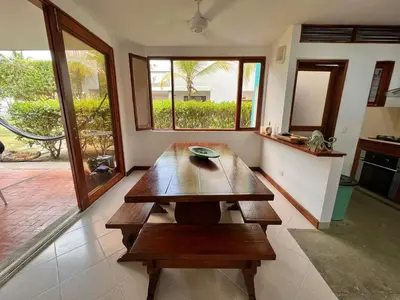 a living room with a wooden table in the middle at Hermosa villa frente al mar in San Silvestre