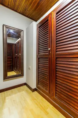 a room with a wooden door and a mirror at Casa Cristi #5 in Cartagena de Indias