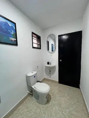 a bathroom with a toilet and a sink at Family house colonial-style in Cartagena de Indias