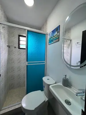 a bathroom with a toilet and a shower and a sink at Family house colonial-style in Cartagena de Indias