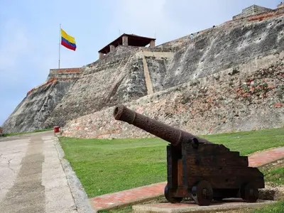 a cannon with a flag on top of a hill at Family house colonial-style in Cartagena de Indias