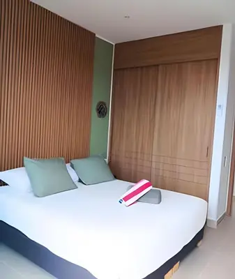 a bedroom with a bed with a book on it at Ultimo piso, amplia terraza y vista impresionante! in Los Arrayanes