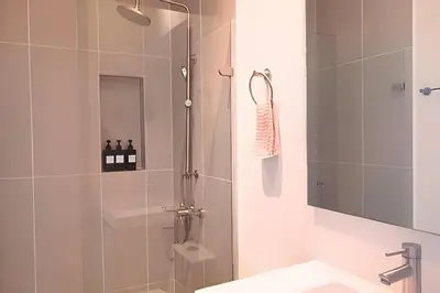 a shower with a glass door in a bathroom at Ultimo piso, amplia terraza y vista impresionante! in Los Arrayanes