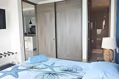 a bedroom with a bed with a blue comforter at Luxury Escape: Sea, Comfort & Style in Cartagena de Indias