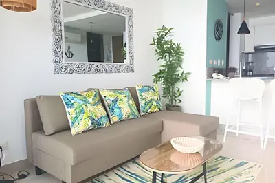 a living room with a couch and a mirror at Luxury Escape: Sea, Comfort & Style in Cartagena de Indias