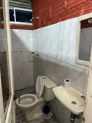 a small bathroom with a toilet and a sink at Hoteles & Restaurantes Doña Nerta in Cartagena de Indias