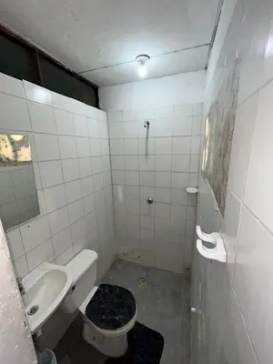 a small bathroom with a toilet and a sink at Hoteles & Restaurantes Doña Nerta in Cartagena de Indias