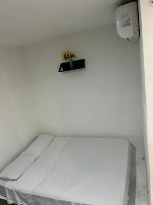 a bed in a room with a white wall at Hoteles & Restaurantes Doña Nerta in Cartagena de Indias