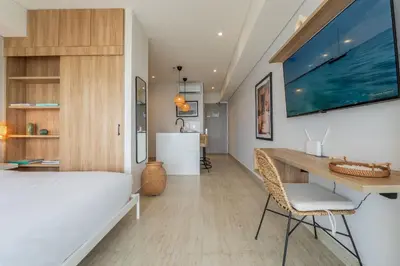 a bedroom with a bed and a desk with a table at CB1515 | Lujosa suite con vista al mar y balcón in Cartagena de Indias