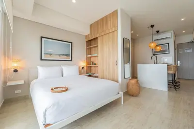 a bedroom with a white bed with a purse on it at CB1515 | Lujosa suite con vista al mar y balcón in Cartagena de Indias